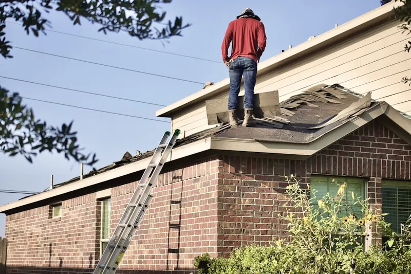 Professional roofer working on a residential roof in Chapel Manor